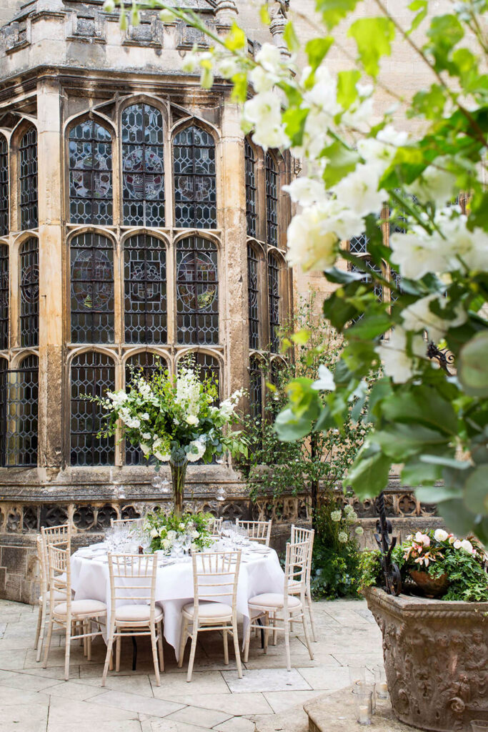 Courtyard with roses hydrangeas delphiniums as centrepieces