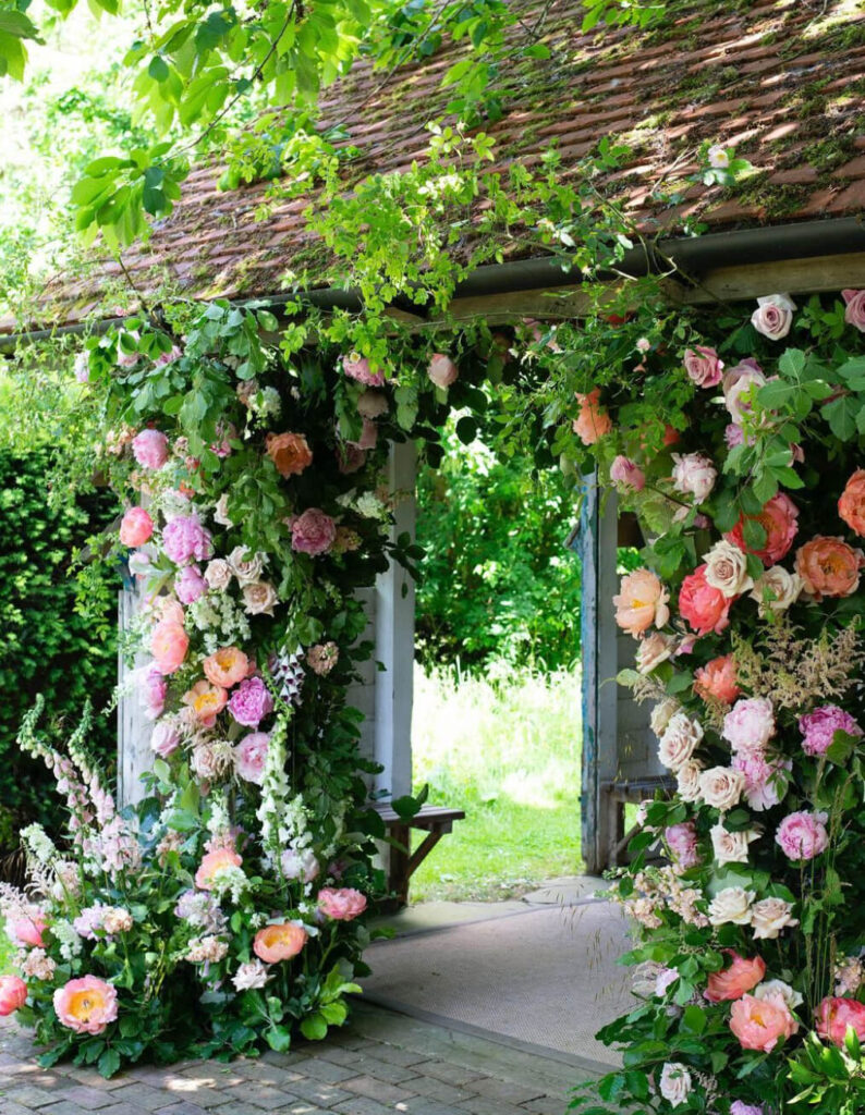 Wedding floral arch side view with foxgloves and peonies