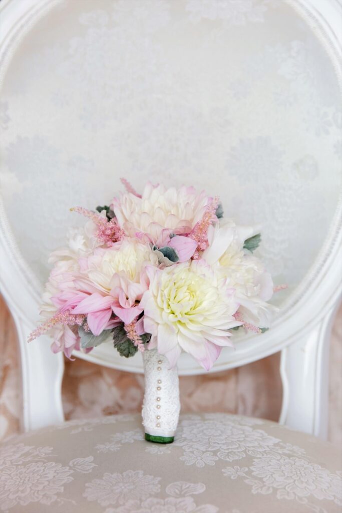 Luxury pink cafe-au-lait wedding bouquet on a white chair