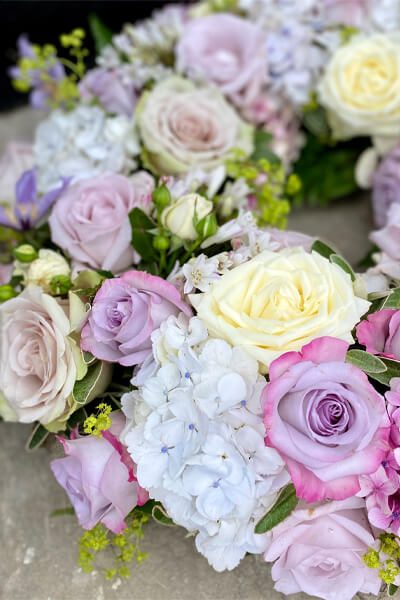 Purple roses, hydrangeas and cream roses in a wreath